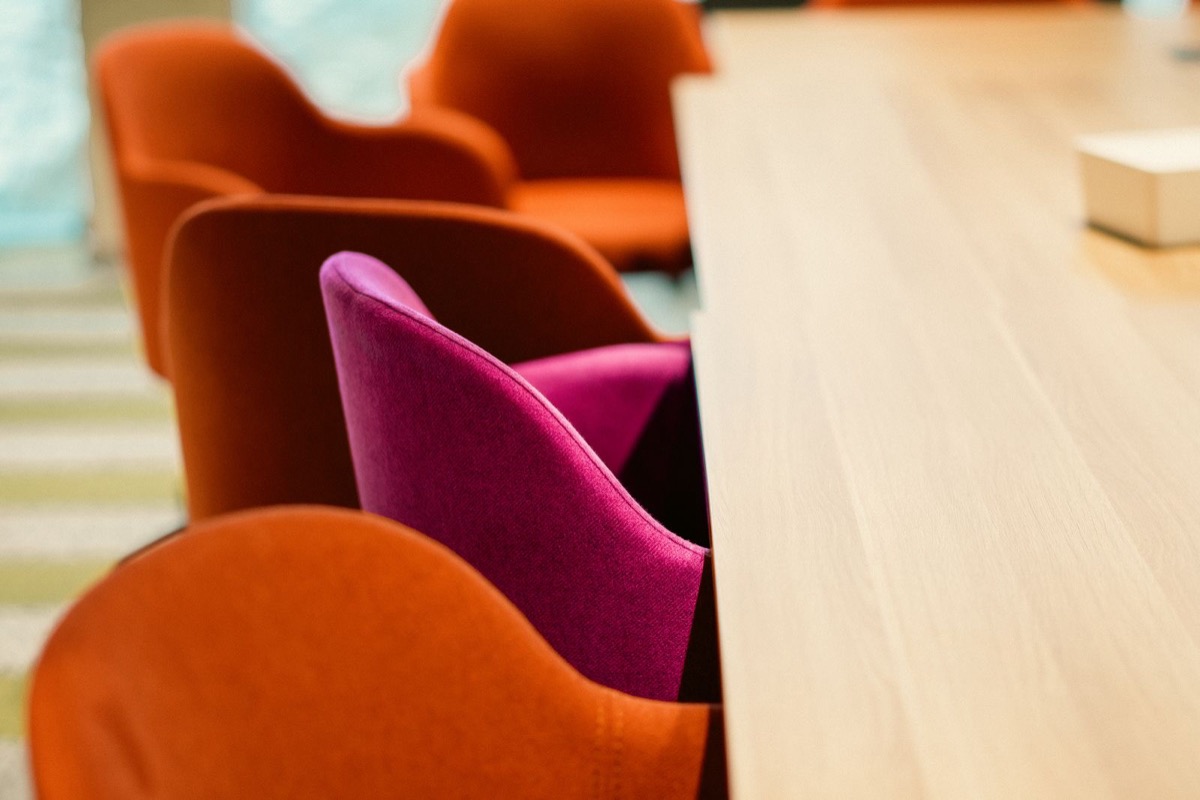 An empty meeting room with a table and chairs in soft daylight